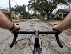 Cyclist adjusting low handlebars on an Austin road bike