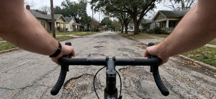 Cyclist adjusting low handlebars on an Austin road bike