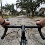 Cyclist adjusting low handlebars on an Austin road bike