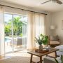 Bright living room with affordable curtains filtering Florida sunlight through large windows.